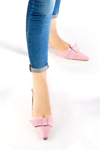 Women's light pink elegant slingback heels, with a bow on the front. Tapered toe. Medium spool heels - Worn view